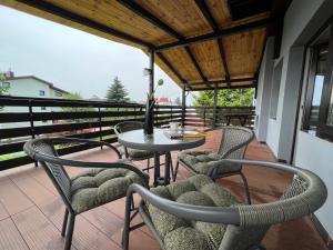 a patio with a table and chairs on a balcony at Apartamenty Romano in Rzeszów