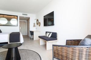 a hotel room with a bed and a table and chairs at Invisa Hotel Club Cala Verde in Es Figueral Beach