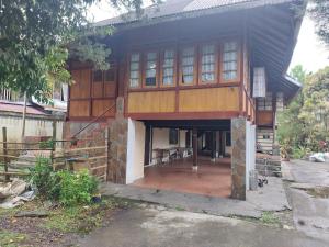 ein Haus, das mit einer Veranda gebaut wird in der Unterkunft Mountain View Homestay in Tomohon