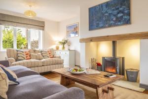 a living room with a couch and a fireplace at Sherborne House in Wells next the Sea