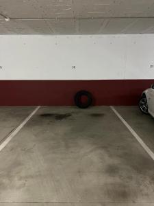 a car parked in a parking garage with a tire at Playa grande Miño travesía in Miño