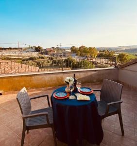 a table with a blue table cloth on a balcony at Home Ilardo in Campobello di Licata