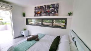 a bedroom with a bed and a window at Galilee Triple Terrace in Tiberias +26 photos