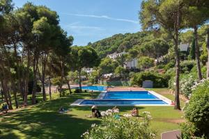 a view of a park with a swimming pool at Amazing Seaview house in Tamariu in Girona