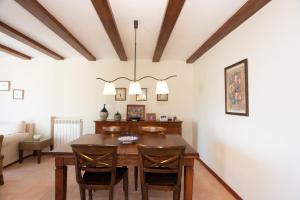 a dining room with a wooden table and chairs at Amazing Seaview house in Tamariu in Girona
