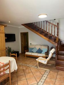 a living room with a couch and a staircase at Casa la melliza VV-3021AS in Mestas de Con
