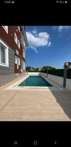 a swimming pool in front of a house at Lilyum in Dalaman