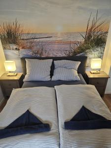 two beds in a room with a view of the ocean at Küstenzauber - Balkon - Tolle Lage - Netflix in Wilhelmshaven