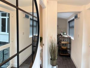 a hallway of a house with a mirror at Cute+Cozy Guesthouse for 2 +secure offroad parking in Fallings Park