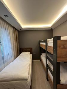 two bunk beds in a room with a window at Netya Suite Hotel in Uzungol
