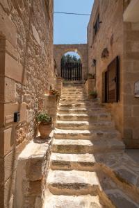 an alley in an old building with stone walls at The Stonemade Houses in Falasarna