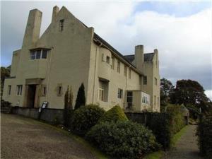 a large white house with two chimneys on it at Snug - Fountain Bank Apartment in Helensburgh