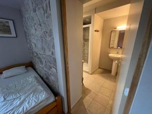 a small bedroom with a bed and a bathroom at Les Gites de Durbuy in Septon +61 photos