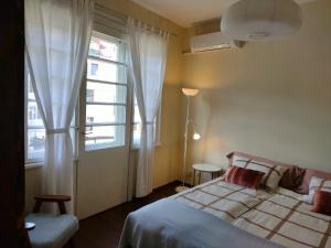 a bedroom with a bed and a window at Art Studio Turnovo in Veliko Tŭrnovo