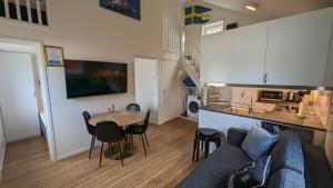 a living room with a couch and a table and a kitchen at Dragsö Camping & Stugby in Karlskrona