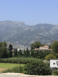 a mountain in the distance with houses and trees at JERDOUH For FAMILY ONLY in Tétouan