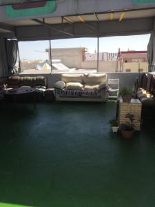 a room with a couch sitting on top of a building at JERDOUH For FAMILY ONLY in Tetouan