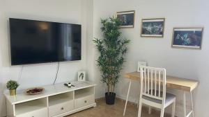 a living room with a tv and a chair and a table at Central Apartment in La Laguna in La Laguna