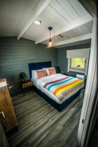 a bedroom with a bed with a colorful blanket at Springfort Hall Hotel in Mallow