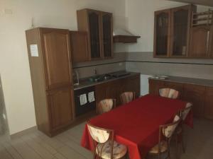 a kitchen with a red table and chairs in it at Room in Guest room - Double room between Padua and Chioggia in Brugine