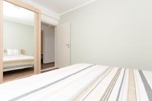 a bedroom with a bed and a large mirror at apartman 2 in Budva