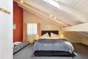 a bedroom with a large bed and red walls at Chalet Eigersunna in Grindelwald