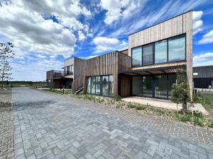 a building with a brick road in front of it at Sea Breeze Solitude in Svencelė