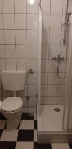 a small bathroom with a toilet and a shower at U Izy i Romana in Jarosławiec