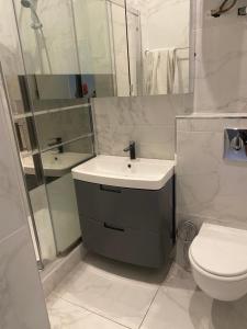a white bathroom with a sink and a toilet at good Time côte d'azur in Nice