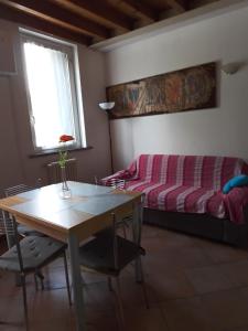 a living room with a table and a couch at B&b del bosco e del lago Elimar in Lecco