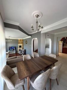 a dining room with a wooden table and chairs at WHİTE HOUSE in Trabzon