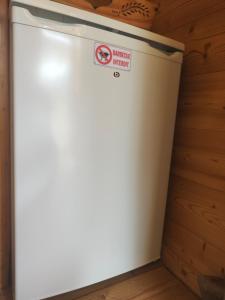 a white refrigerator in a room with a wall at Chambre Trèfle in Entremont