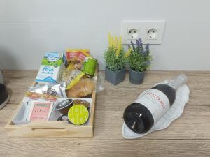 a bottle of wine and some food on a table at Apartamento Pie de Playa, El Puntal-Villaviciosa in Villaviciosa