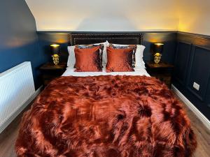 a large bed in a bedroom with two lamps on tables at Roslin Templar loft in Roslin