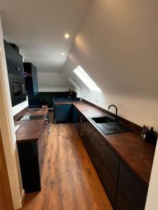 a kitchen with wooden floors and a large counter top at Roslin Templar loft in Roslin