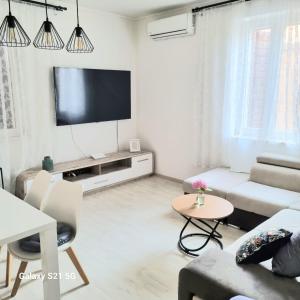 a white living room with a flat screen tv at Sara in Podstrana