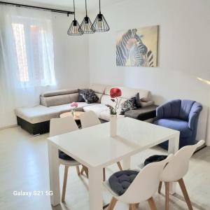 a living room with a white table and chairs at Sara in Podstrana