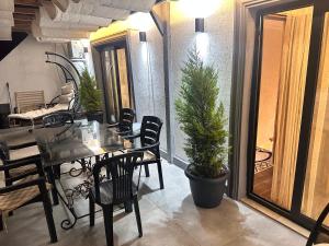 a dining room with a table and a potted tree at Villa view Fethiye in Fethiye