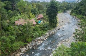 an aerial view of a river next to a house at Casitas Del Rio Riverfront Jungle Beach Vacation in Uvita