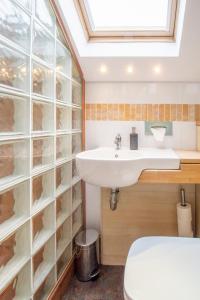 a bathroom with a sink and a toilet at Almada Apartment in Hamilton