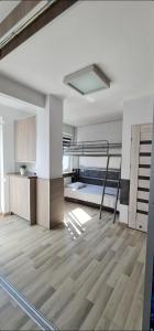 a bedroom with a bunk bed in a room with wooden floors at Dom Wypoczynkowy Oliwka in Ustka