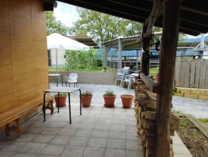 a patio with a table and chairs and a bench at Alarpe Aterpetxea in Zaldivia
