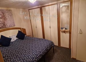 a bedroom with a bed and a sign that says let is caravan at wildlife bay at Let's Caravan at Whitley Bay in Whitley Bay