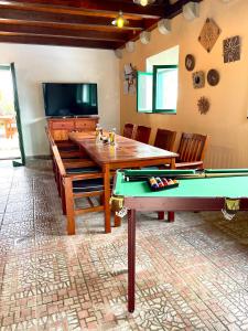 a dining room with a pool table and a tv at Villa Sagosde with Swimming Pool and Mini Golf in Zagvozd