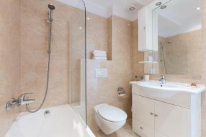 a bathroom with a shower and a toilet and a sink at Villa Mare Crikvenica in Crikvenica