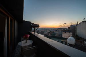 a balcony with a table and a view of a city at Pera Luna Premium Hotel in Istanbul