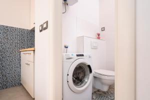 a bathroom with a washing machine and a toilet at Main Square Apartment in Hvar