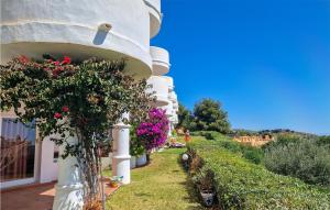 a house with flowers on the side of it at Lovely Apartment In Mijas With Wifi in Mijas +8 photos