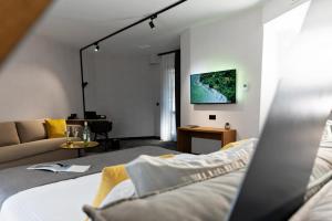 a living room with a bed and a couch at MM Boutique Hotel in Burgas