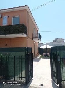 a building with a green fence next to a building at Sun House in Montesilvano